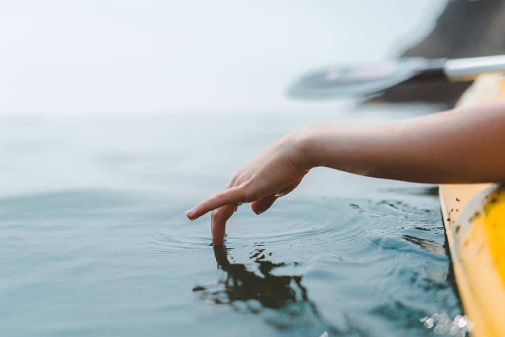 Person Touching Body of Water