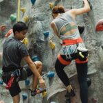 Two people rock climbing together symbolize trust, teamwork, and support through shared challenges and growth.