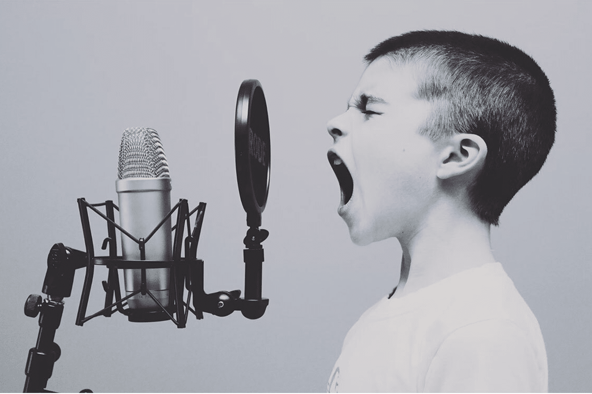 A Kid Singing in a Music Studio