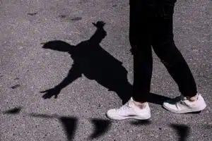 Person walking with shadow, reflecting, mindfulness, emotional healing, marriage counselling Singapore support