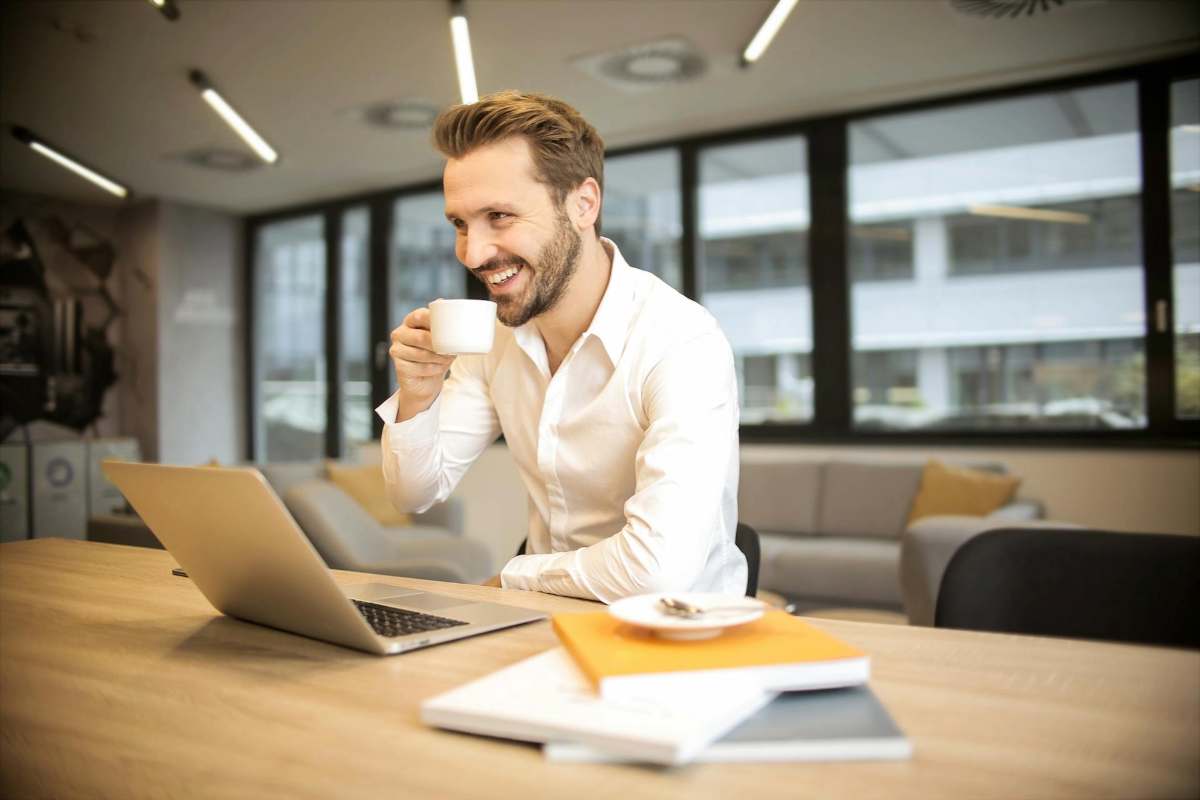 Professional taking a coffee break at work, symbolizing stress relief and work-life balance counselling in Singapore.