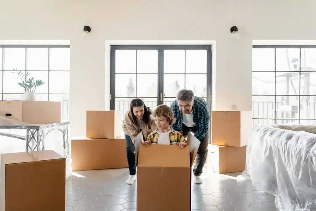 Parents supporting their child during a move, reflecting calm and responsive parenting skills developed through parenting therapy.