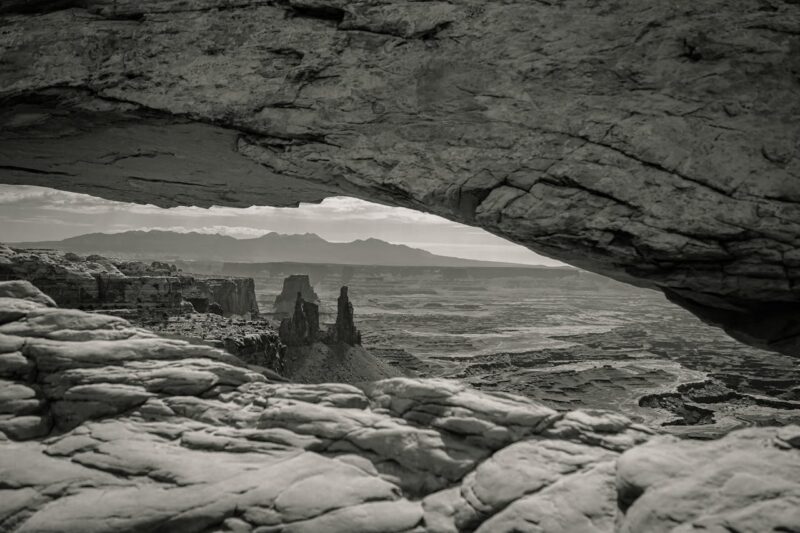 Rock arch framing a vast, empty landscape symbolizing the search for meaning during an existential crisis.