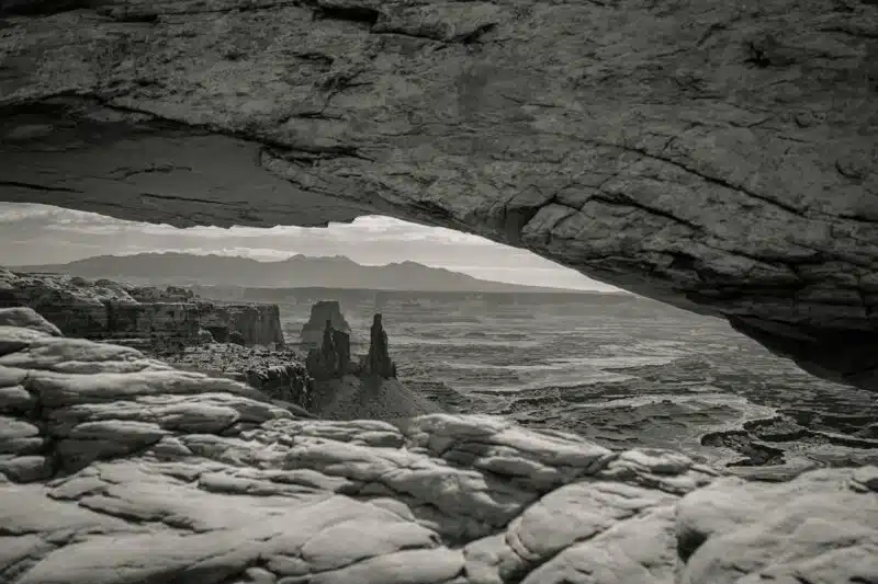 Rock arch framing a vast, empty landscape symbolizing the search for meaning during an existential crisis.