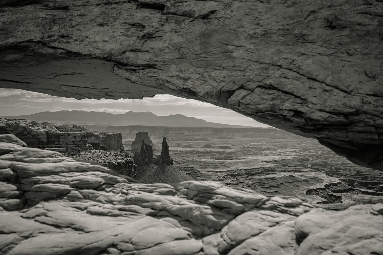Rock arch framing a vast, empty landscape symbolizing the search for meaning during an existential crisis.