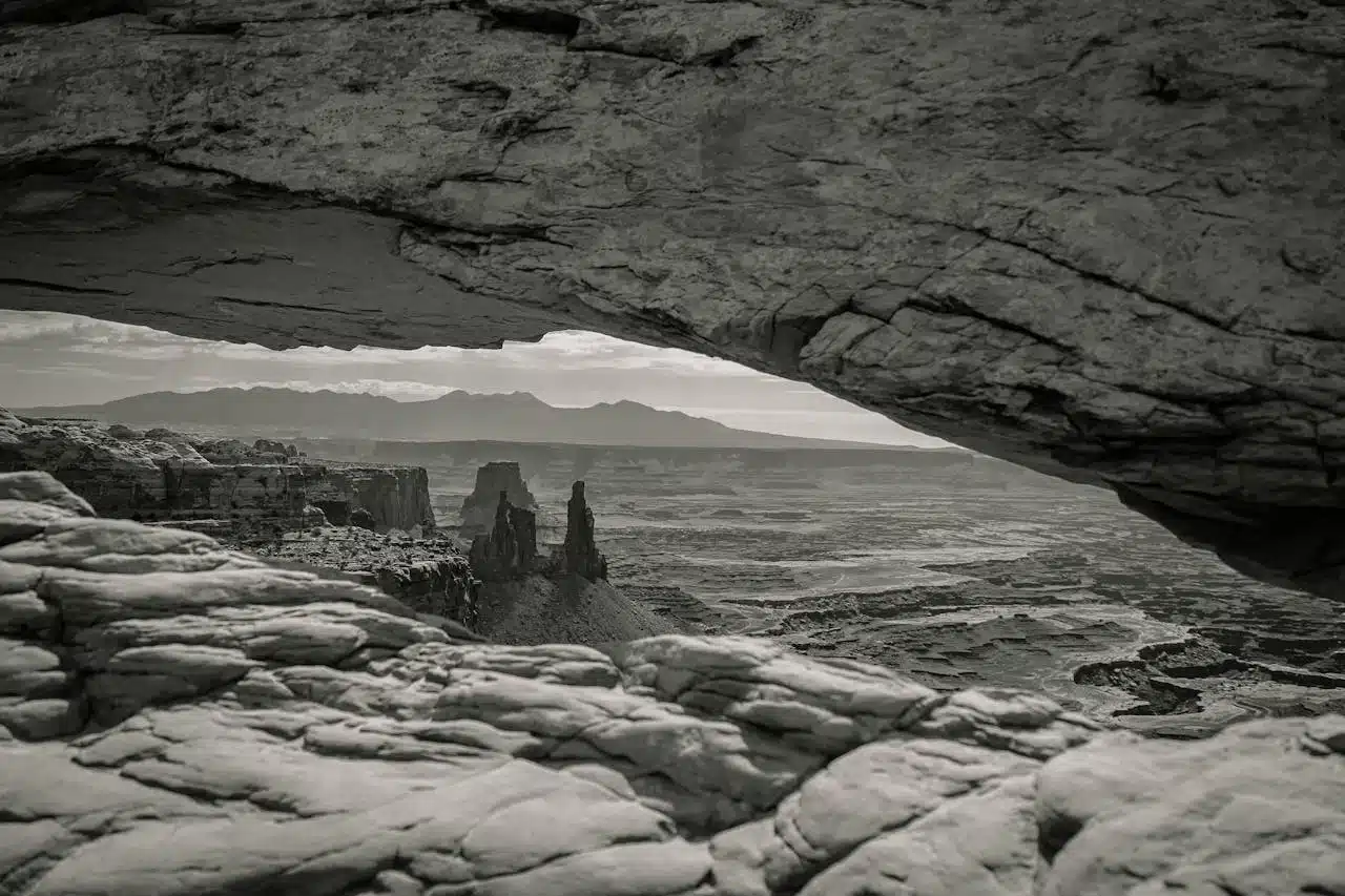 Rock arch framing a vast, empty landscape symbolizing the search for meaning during an existential crisis.