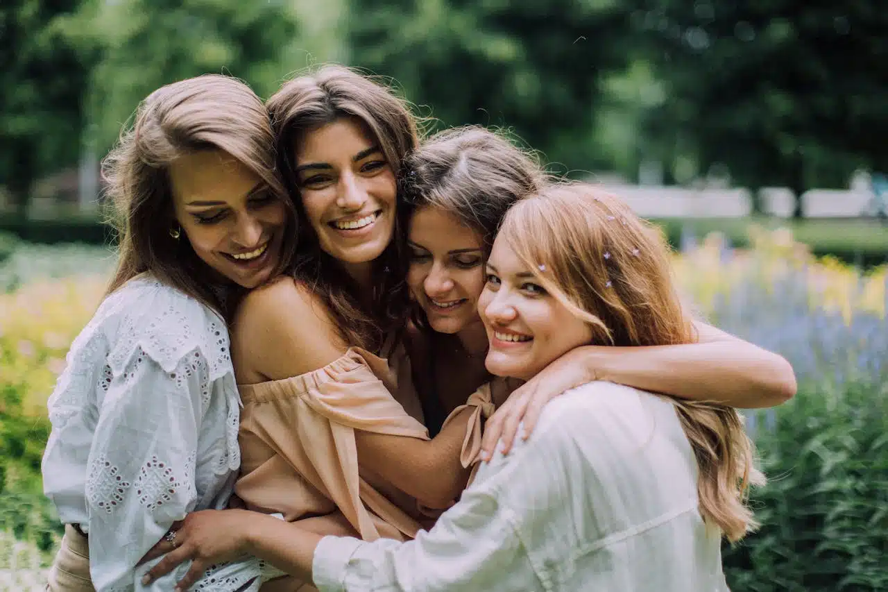 Group of women embracing outdoors, symbolizing emotional support and connection in group therapy
